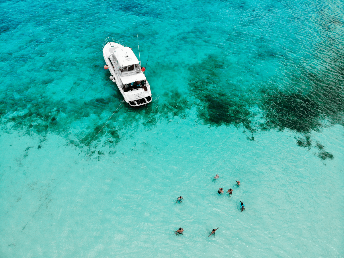 Aerial view of a yacht over turquoise Caribbean water